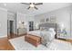 This primary bedroom features a door to a walk-in closet, mirrored nightstands, and hardwood flooring at 204 Oxford Mill Ct, Cary, NC 27518