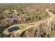 Expansive aerial view of the golf course with sand traps and putting green, surrounded by mature trees and residential areas at 222 Kelso Ct, Cary, NC 27511