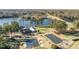 Aerial shot of golf course and waterfront property, featuring a clubhouse, lush landscaping, and a serene lake at 222 Kelso Ct, Cary, NC 27511