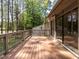 Spacious wooden deck with sliding glass doors leading inside and wooded backyard at 222 Kelso Ct, Cary, NC 27511