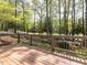 Wooden deck with a view of lush greenery and mature trees in the backyard at 222 Kelso Ct, Cary, NC 27511