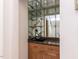 Stylish bar area featuring granite counters, wood cabinets, a sink, and mirrored shelving at 222 Kelso Ct, Cary, NC 27511