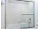 Bathroom shower with a sliding glass door, white tile, and chrome fixtures at 222 Kelso Ct, Cary, NC 27511