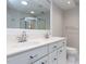 Bright bathroom featuring dual sinks, a large mirror, and a glass enclosed shower at 222 Kelso Ct, Cary, NC 27511