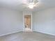 Neutral bedroom with en-suite bathroom with a ceiling fan and two windows at 222 Kelso Ct, Cary, NC 27511