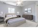 Bedroom featuring a large bed, ceiling fan, bedside lamps, and art on the wall at 222 Kelso Ct, Cary, NC 27511