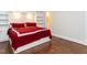 This bedroom features hardwood floors, built-in shelving, and a red and white bed set at 222 Kelso Ct, Cary, NC 27511