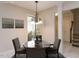 Cozy dining area showcasing a chandelier, paintings, and a view to a garden at 222 Kelso Ct, Cary, NC 27511