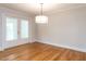 Clean, bright dining room with hardwood floors and a modern pendant light fixture at 222 Kelso Ct, Cary, NC 27511