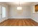 Bright dining room with hardwood floors, neutral walls, and a modern light fixture at 222 Kelso Ct, Cary, NC 27511