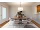 Bright dining room featuring a modern light fixture and a decorative rug under an oval dining table at 222 Kelso Ct, Cary, NC 27511