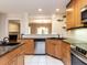 Spacious kitchen featuring granite counters, stainless steel appliances, tile backsplash, and wood cabinets at 222 Kelso Ct, Cary, NC 27511