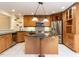 Well-equipped kitchen featuring wood cabinets, granite countertops, a kitchen island, and stainless steel appliances at 222 Kelso Ct, Cary, NC 27511