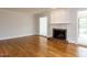 Spacious living room showcasing hardwood floors, a fireplace, and plenty of natural light at 222 Kelso Ct, Cary, NC 27511