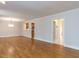 Open-concept living space boasting hardwood floors and access to other rooms at 222 Kelso Ct, Cary, NC 27511