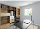 This home office has custom shelving, modern desk, and a comfortable black chair at 222 Kelso Ct, Cary, NC 27511