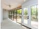 Open screened porch with wooded backyard views and multiple ceiling fans at 222 Kelso Ct, Cary, NC 27511