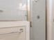 Walk-in shower with white tiled walls, glass door and chrome fixtures at 222 Kelso Ct, Cary, NC 27511