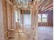 Bathroom area during construction with framing, window, and visible space for bathtub at 223 Pond Vw Ct # 10, Fuquay Varina, NC 27526