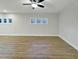 Bonus room with wood-look flooring, ceiling fan, and natural light at 223 Pond Vw Ct # 10, Fuquay Varina, NC 27526