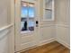 Bright entryway with glass front door, wood floors, and painted wainscoting at 223 Pond Vw Ct # 10, Fuquay Varina, NC 27526