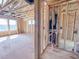 Hallway under construction showing framing, ductwork, and plumbing, with views into a large room at 223 Pond Vw Ct # 10, Fuquay Varina, NC 27526