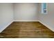 Bright room with wood-look floors, white trim, and a window at 223 Pond Vw Ct # 10, Fuquay Varina, NC 27526