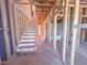 New construction showing a staircase with protective plastic wrap, with framing and an unfinished room at 223 Pond Vw Ct # 10, Fuquay Varina, NC 27526