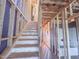 New construction stairway with protective plastic, showing studs, wiring, and unfinished rooms at 223 Pond Vw Ct # 10, Fuquay Varina, NC 27526