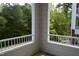 Private balcony offering a peaceful outdoor space with a view of lush greenery at 224 Eyam Hall Ln, Apex, NC 27502
