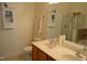 Bright bathroom featuring a double sink vanity, mirrored wall cabinet, and a glass-enclosed shower at 224 Eyam Hall Ln, Apex, NC 27502