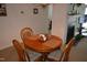 Cozy dining area with a round table, seating for four, and a fireplace view at 224 Eyam Hall Ln, Apex, NC 27502