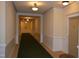 Well-lit hallway with carpet leading to unit doors, creating a welcoming entrance at 224 Eyam Hall Ln, Apex, NC 27502