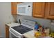 Efficient kitchen layout featuring white appliances, ample counter space, and wooden cabinetry at 224 Eyam Hall Ln, Apex, NC 27502