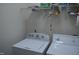 Practical laundry room with a washer, dryer, and storage for cleaning supplies at 224 Eyam Hall Ln, Apex, NC 27502