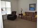 Cozy living room featuring comfortable seating and a window with natural lighting at 224 Eyam Hall Ln, Apex, NC 27502
