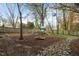 Large, open backyard with a play area, bordered by a wooden fence at 2256 W Front St, Burlington, NC 27215