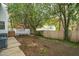 Backyard featuring a spacious deck, wooden fence, and mature trees, creating a private outdoor space at 2256 W Front St, Burlington, NC 27215