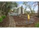 Spacious backyard featuring a deck, mature trees, rock garden, and play area, perfect for outdoor enjoyment at 2256 W Front St, Burlington, NC 27215