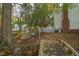 Backyard showcasing a charming play set, wooden bridge, and mature trees creating a serene environment at 2256 W Front St, Burlington, NC 27215