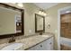 Bathroom features dual sinks with granite countertops, framed mirrors, and tile floor at 2256 W Front St, Burlington, NC 27215