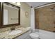 Bathroom featuring a single vanity with granite countertops, large mirror, tile shower and floors at 2256 W Front St, Burlington, NC 27215