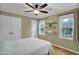 Bedroom features wood floors, large windows, ceiling fan, and shelves at 2256 W Front St, Burlington, NC 27215