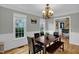 Traditional dining room featuring hardwood floors, chandelier, wainscoting and plenty of natural light at 2256 W Front St, Burlington, NC 27215