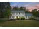 Charming two-story home featuring classic shutters, a well-manicured lawn, and lush landscaping at 2256 W Front St, Burlington, NC 27215