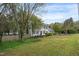 Two-story home features classic shutters, a well-manicured lawn, and mature trees at 2256 W Front St, Burlington, NC 27215