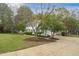 Two-story home features classic shutters, a well-manicured lawn, and mature trees at 2256 W Front St, Burlington, NC 27215
