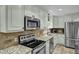 Bright kitchen with stainless appliances, granite countertops, tiled backsplash and flooring at 2256 W Front St, Burlington, NC 27215