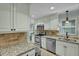 Bright kitchen with stainless appliances, granite countertops, tiled backsplash and flooring at 2256 W Front St, Burlington, NC 27215