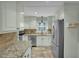 Bright kitchen with stainless appliances, granite countertops, tiled backsplash and flooring at 2256 W Front St, Burlington, NC 27215
